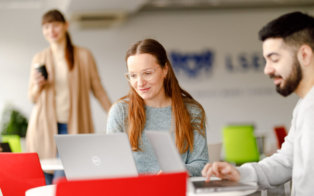 LSEG employees working at computers in a modern office – company branding photography with a natural, casual work atmosphere