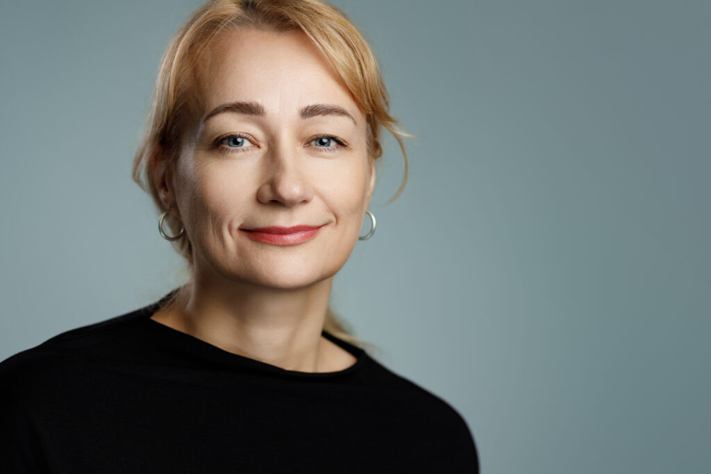 Natural Female Headshot with Minimalist Style Clean professional headshot of a woman with minimal styling, perfect for LinkedIn and team pages.
