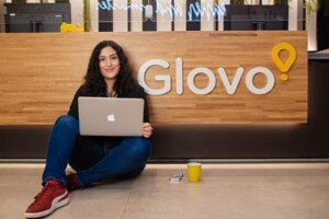 Glovo employee with a laptop outside the office in Barcelona – corporate branding photography